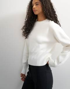Model wearing Knitted clean cinch waist batwing sleeve jumper in ivory