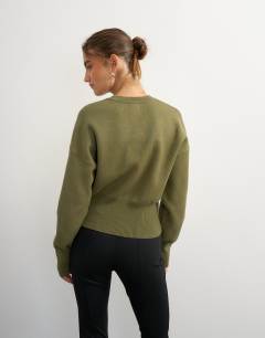 Model wearing Knitted clean cinch waist batwing sleeve jumper in khaki