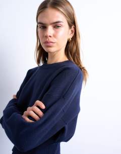 Model wearing Knitted clean cinch waist jumper in navy