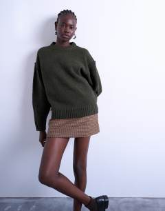 Model wearing Knitted clean exposed seam jumper in khaki