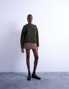 Model wearing Knitted clean exposed seam jumper in khaki
