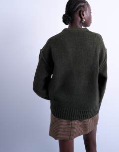 Model wearing Knitted clean exposed seam jumper in khaki