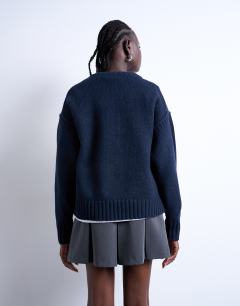 Model wearing Knitted clean exposed seam jumper in navy