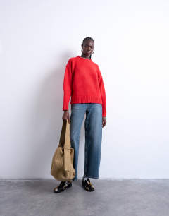 Model wearing Knitted clean exposed seam jumper in red