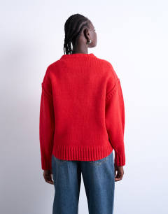 Model wearing Knitted clean exposed seam jumper in red