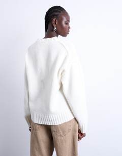 Model wearing Knitted clean exposed seam jumper in White