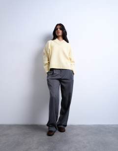 Model wearing Knitted clean premium lambswool v neck jumper in yellow
