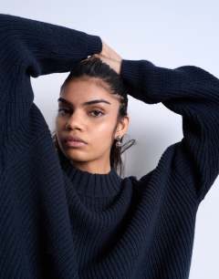 Model wearing Knitted clean wide rib neck jumper in navy