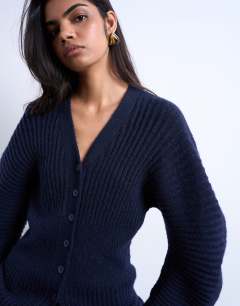 Model wearing Knitted cocoon sleeve cinch cardigan in navy