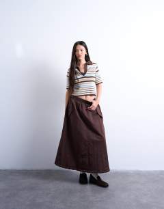 Model wearing Knitted collared polo in brown stripe