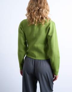 Model wearing Knitted compact balloon sleeve cardigan in green