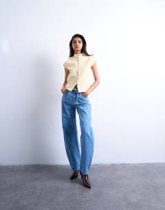 Model wearing Knitted compact cap sleeve waistcoat in Buttermilk