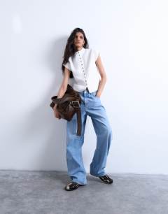 Model wearing Knitted compact cap sleeve waistcoat in Ivory
