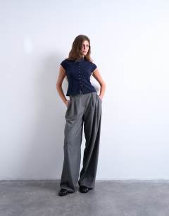 Model wearing Knitted compact cap sleeve waistcoat in Navy