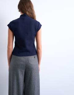 Model wearing Knitted compact cap sleeve waistcoat in Navy