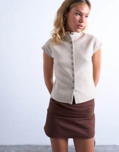Model wearing Knitted compact cap sleeve waistcoat in oat