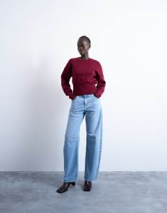 Model wearing Knitted compact fitted waist jumper in burgundy
