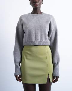 Model wearing Knitted compact fitted waist jumper in grey