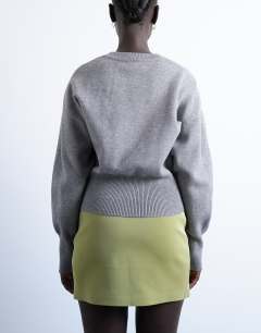 Model wearing Knitted compact fitted waist jumper in grey