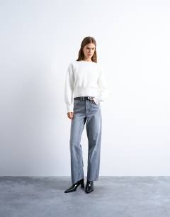 Model wearing Knitted compact fitted waist jumper in ivory