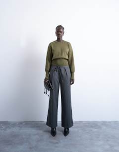 Model wearing Knitted compact fitted waist jumper in khaki