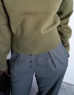 Model wearing Knitted compact fitted waist jumper in khaki