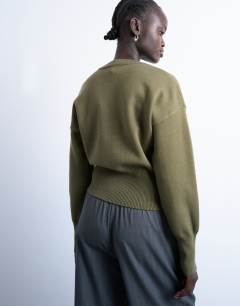 Model wearing Knitted compact fitted waist jumper in khaki