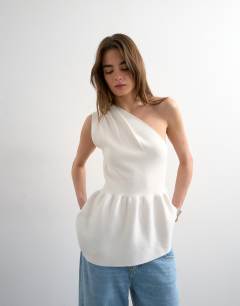 Model wearing Knitted compact peplum one shoulder top in ivory