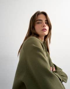 Model wearing Knitted compact utility cinch polo in khaki