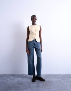 Model wearing Knitted compact waistcoat in buttermilk
