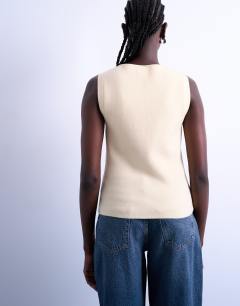 Model wearing Knitted compact waistcoat in buttermilk