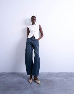 Model wearing Knitted compact waistcoat in ivory
