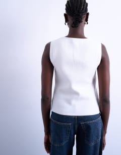 Model wearing Knitted compact waistcoat in ivory