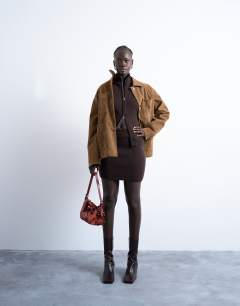Model wearing Knitted compact zip through funnel jumper in chocolate
