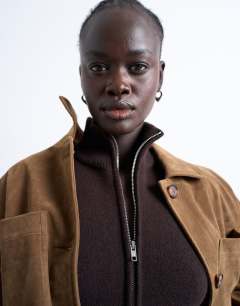 Model wearing Knitted compact zip through funnel jumper in chocolate