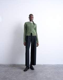 Model wearing Knitted covered button cardigan in green