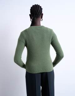 Model wearing Knitted covered button cardigan in green