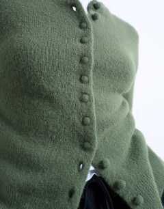 Model wearing Knitted covered button cardigan in green