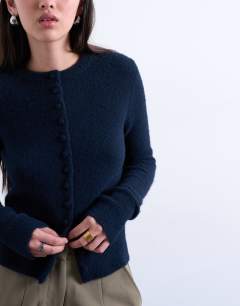 Model wearing Knitted covered button cardigan in navy