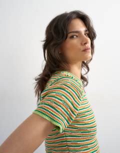 Model wearing Knitted crew neck stripe short sleeve top in multi