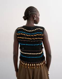 Model wearing Knitted crochet beaded tank in black