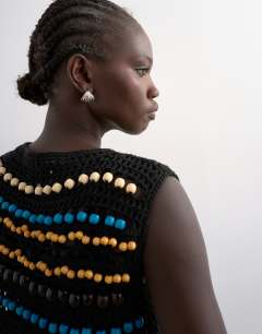 Model wearing Knitted crochet beaded tank in black