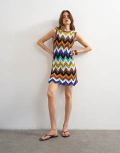 Model wearing Knitted crochet chevron mini dress in multi
