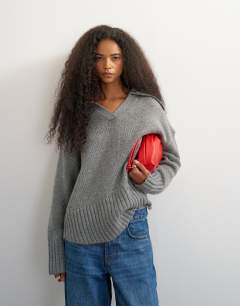 Model wearing Knitted curved hem collared polo jumper with wool in charcoal