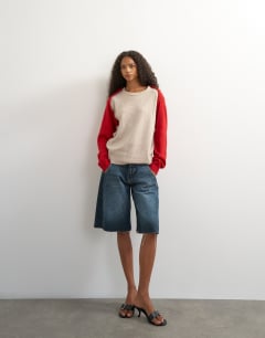 Model wearing Knitted detachable wrap scarf jumper in neutral and red