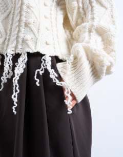 Model wearing Knitted distressed cable jumper in ivory