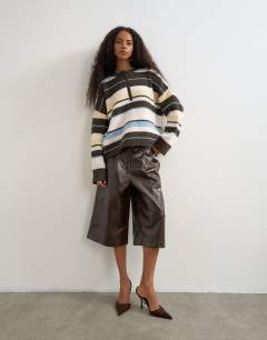Model wearing Knitted easy Henley jumper in multi