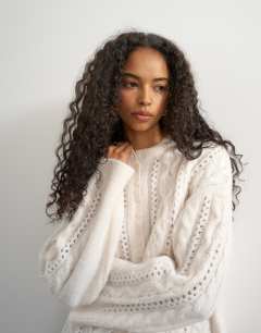 Model wearing Knitted easy Henley neck cable jumper in oat