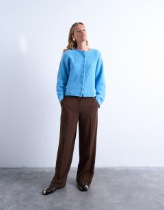 Model wearing Knitted easy ribbed relaxed cardigan in blue