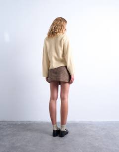 Model wearing Knitted easy ribbed relaxed cardigan in buttermilk